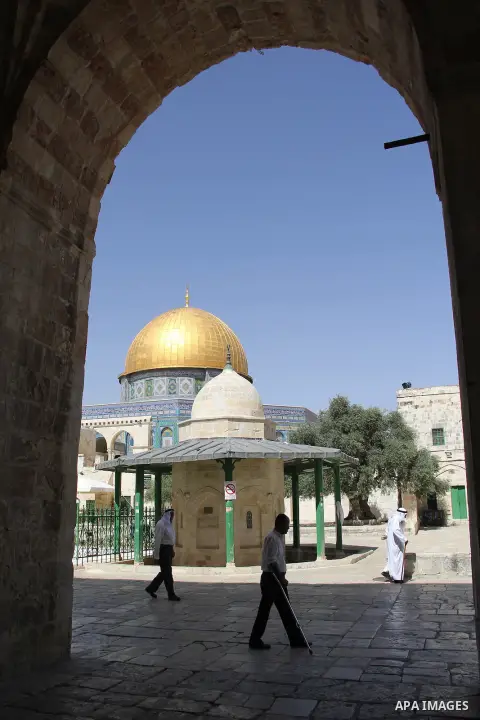 Palestinians Muslims walk walk in front of the Dome of the Rock mosque, in Jerusalem's old city on June 7, 2016. Ramadan is sacred to Muslims because it is during that month that tradition says the Koran was revealed to...