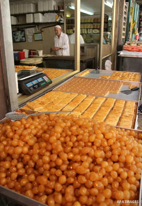 Palestinians shop at a market on the second day of the Ramadan in Jerusalem's old city on June 7, 2016. Ramadan is sacred to Muslims because it is during that month that tradition says the Koran was revealed to the Proph...