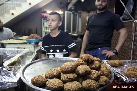 Palestinians shop at a market on the second day of the Ramadan in Jerusalem's old city on June 7, 2016. Ramadan is sacred to Muslims because it is during that month that tradition says the Koran was revealed to the Proph...