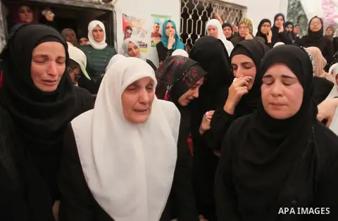 Relatives of Palestinian Jamal Dwikat, who died from wounds he sustained after he was shot during clashes with the Israeli army on Friday, mourn during his funeral in the West Bank village of Balata Albalad near Nablus J...