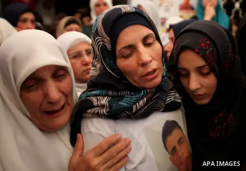 Relatives of Palestinian Jamal Dwikat, who died from wounds he sustained after he was shot during clashes with the Israeli army on Friday, mourn during his funeral in the West Bank village of Balata Albalad near Nablus J...