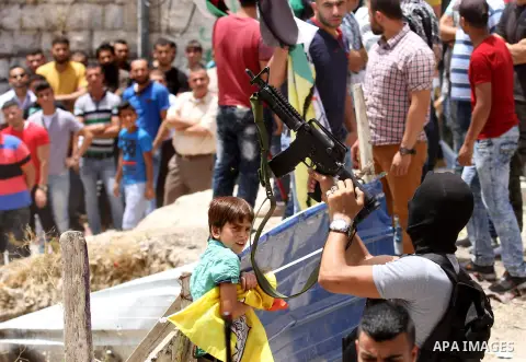 Mourners carry the body of Palestinian Jamal Dwikat, who died from wounds he sustained after he was shot during clashes with the Israeli army on Friday, during his funeral in the West Bank village of Balata Albalad near...