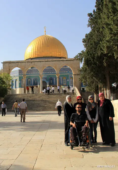 Palestinians Muslims walk walk in front of the Dome of the Rock mosque, in Jerusalem's old city on June 8, 2016. Ramadan is sacred to Muslims because it is during that month that tradition says the Koran was revealed to...