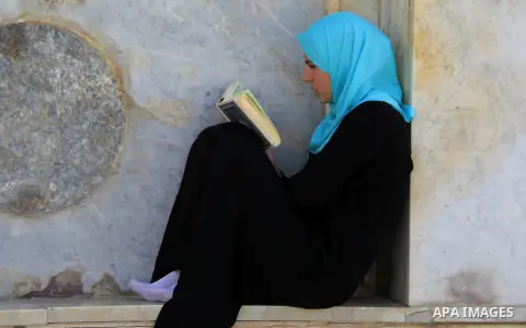 A Palestinian woman reads holy Koran, Islam's holy book, at al-Aqsa mosque, in Jerusalem's old city on June 8, 2016. Ramadan is sacred to Muslims because it is during that month that tradition says the Koran was revealed...