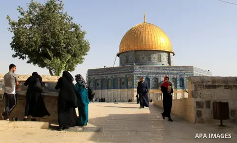 Palestinians Muslims walk walk in front of the Dome of the Rock mosque, in Jerusalem's old city on June 8, 2016. Ramadan is sacred to Muslims because it is during that month that tradition says the Koran was revealed to...