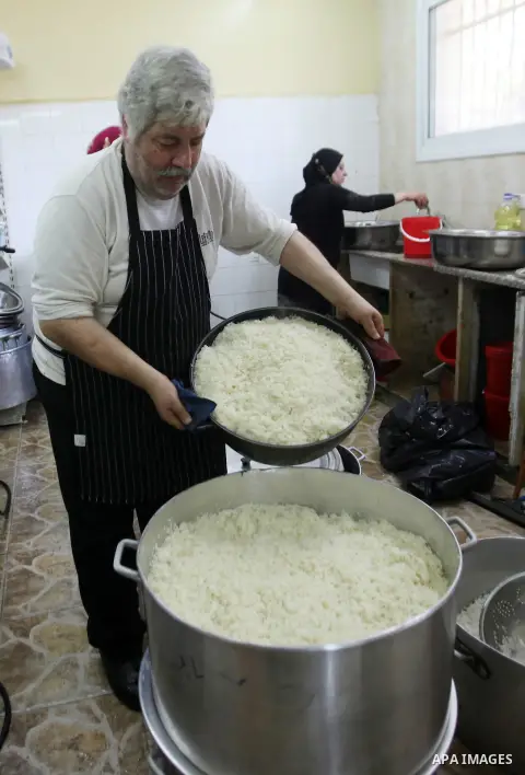A Palestinian man prepares food for the poor Palestinians from an Islamic charity "Tekkia" in the West Bank city of Nablus on the holy month of Ramadan on June 09, 2016. Ramadan is sacred to Muslims because it is during...