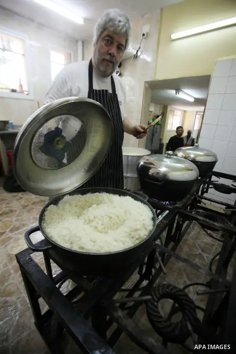 A Palestinian man prepares food for the poor Palestinians from an Islamic charity "Tekkia" in the West Bank city of Nablus on the holy month of Ramadan on June 09, 2016. Ramadan is sacred to Muslims because it is during...
