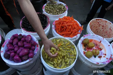 A Palestinian man sells pickles at a market during the Muslim holy fasting month of Ramadan in Rafah in the southern Gaza strip, on June 9, 2016. Photo by Abed Rahim Khatib