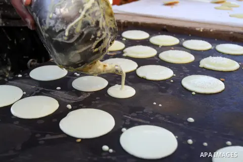A Palestinian man prepares traditional pancakes known as ''Qatayef at a market during the Muslim holy fasting month of Ramadan in Rafah in the southern Gaza strip, on June 9, 2016. Photo by Abed Rahim Khatib