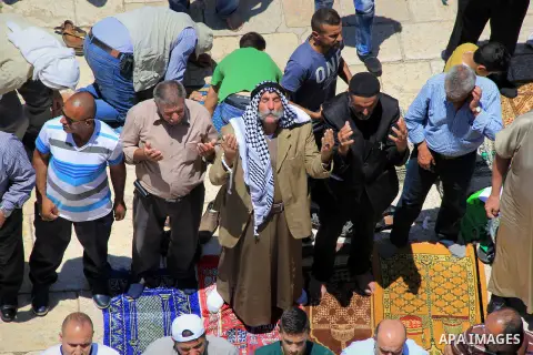 Palestinians pray in front of the Dome of the Rock at Jerusalem's Al-Asqa mosque compound during the first Friday prayers of the holy Muslim fasting month of Ramadan on June 10, 2016. Praying at the site, the third-holie...