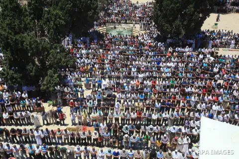 Palestinians pray in front of the Dome of the Rock at Jerusalem's Al-Asqa mosque compound during the first Friday prayers of the holy Muslim fasting month of Ramadan on June 10, 2016. Praying at the site, the third-holie...