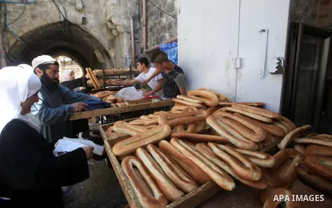 A Palestinian vendor sells cookies at Jerusalem old city during the first Friday prayers of the holy Muslim fasting month of Ramadan on June 10, 2016. Praying at the site, the third-holiest in Islam, is especially import...