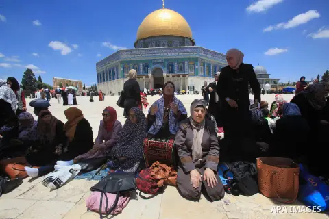 Palestinians pray in front of the Dome of the Rock at Jerusalem's Al-Asqa mosque compound during the first Friday prayers of the holy Muslim fasting month of Ramadan on June 10, 2016. Praying at the site, the third-holie...