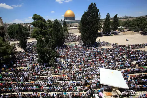Palestinians pray in front of the Dome of the Rock at Jerusalem's Al-Asqa mosque compound during the first Friday prayers of the holy Muslim fasting month of Ramadan on June 10, 2016. Praying at the site, the third-holie...