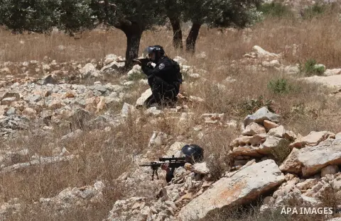 Israeli security forces aim at Palestinian protesters during clashes following a demonstration against the expropriation of Palestinian land by Israel, on June 10, 2016. in the village of Kfar Qaddum, near Nablus, in the...