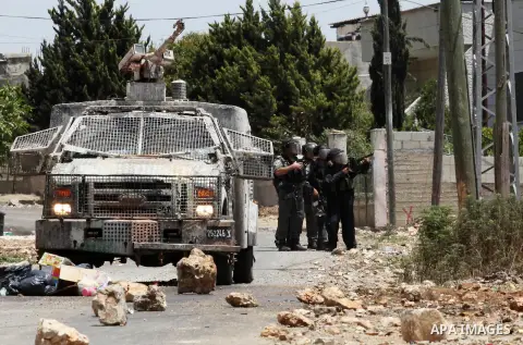 Israeli security forces aim at Palestinian protesters during clashes following a demonstration against the expropriation of Palestinian land by Israel, on June 10, 2016. in the village of Kfar Qaddum, near Nablus, in the...