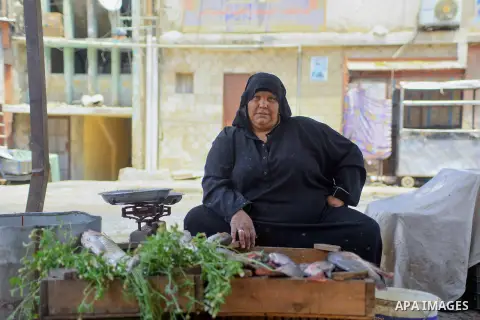 An Egyptian woman displays fishes at her shop on the holy month of Ramadan at a fishes market at the Imbaba area in Cairo, Egypt, on June 11, 2016. Ramadan is sacred to Muslims because it is during that month that tradit...