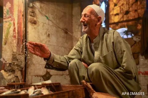 An Egyptian vendor displays fishes at his shop on the holy month of Ramadan at a fishes market at the Imbaba area in Cairo, Egypt, on June 11, 2016. Ramadan is sacred to Muslims because it is during that month that tradi...