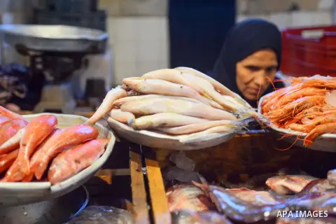 An Egyptian woman displays fishes at her shop on the holy month of Ramadan at a fishes market at the Imbaba area in Cairo, Egypt, on June 11, 2016. Ramadan is sacred to Muslims because it is during that month that tradit...