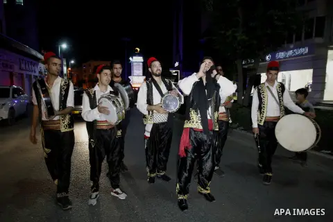 Palestinians dawn awakener "al-Musaharati" walk through streets to wake up Muslims for a meal before sunrise during the fasting month of Ramadan, in the West Bank city of Hebron city on June 12, 2016. Al-Musaharati is an...