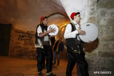 Palestinians dawn awakener "al-Musaharati" walk through streets to wake up Muslims for a meal before sunrise during the fasting month of Ramadan, in the West Bank city of Hebron city on June 12, 2016. Al-Musaharati is an...