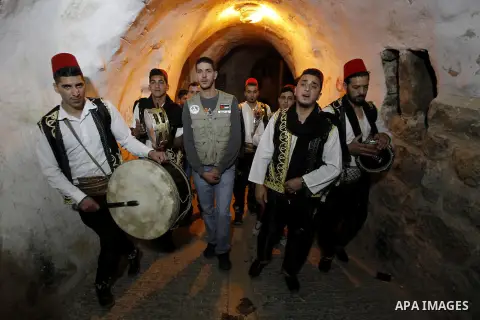 Palestinians dawn awakener "al-Musaharati" walk through streets to wake up Muslims for a meal before sunrise during the fasting month of Ramadan, in the West Bank city of Hebron city on June 12, 2016. Al-Musaharati is an...