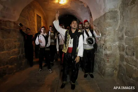 Palestinians dawn awakener "al-Musaharati" walk through streets to wake up Muslims for a meal before sunrise during the fasting month of Ramadan, in the West Bank city of Hebron city on June 12, 2016. Al-Musaharati is an...