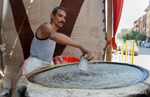 An Egyptian man prepares a traditional sweets "Konafa" on the holy month of Ramadan, in Cairo, Egypt, on June 12, 2016. Ramadan is sacred to Muslims because it is during that month that tradition says the Koran was revea...