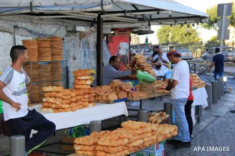 A Palestinian man sells bread at a market during the Muslim holy fasting month of Ramadan in Jerusalem's old city on June, 12, 2016. Ramadan is sacred to Muslims because it is during that month that tradition says the Ko...
