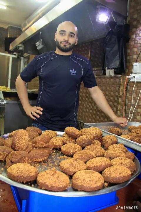 A Palestinian man prepares traditional Falafel at a market during the Muslim holy fasting month of Ramadan in Jerusalem's old city on June, 12, 2016. Ramadan is sacred to Muslims because it is during that month that trad...