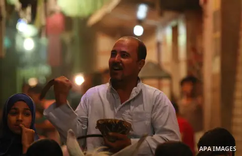 An Egyptian dawn awakener "al-Musaharati" ride a donkey through streets to wake up Muslims for a meal before sunrise during the fasting month of Ramadan, in Cairo, Egypt, on June 13, 2016. Al-Musaharati is an old profess...