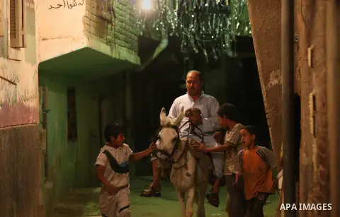 An Egyptian dawn awakener "al-Musaharati" ride a donkey through streets to wake up Muslims for a meal before sunrise during the fasting month of Ramadan, in Cairo, Egypt, on June 13, 2016. Al-Musaharati is an old profess...