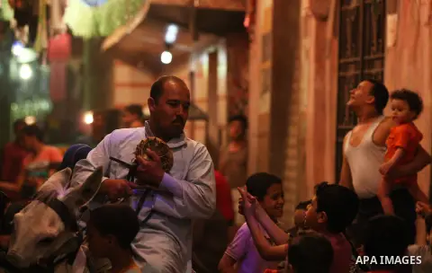 An Egyptian dawn awakener "al-Musaharati" ride a donkey through streets to wake up Muslims for a meal before sunrise during the fasting month of Ramadan, in Cairo, Egypt, on June 13, 2016. Al-Musaharati is an old profess...