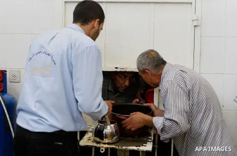 Palestinians prepare food to be distributed for free during the holy fasting month of Ramadan in the West Bank city of Hebron, 13 June 2016. the "Ibrahimi Takiya" was founded in 960 AD as an institute provides food for o...
