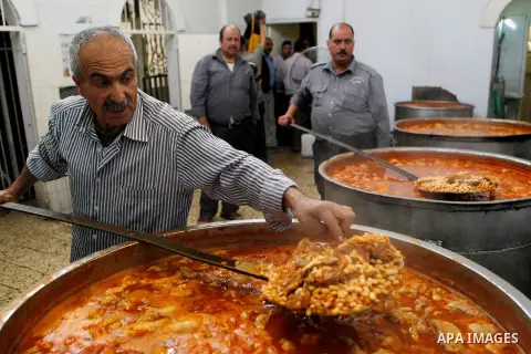 Palestinians prepare food to be distributed for free during the holy fasting month of Ramadan in the West Bank city of Hebron, 13 June 2016. the "Ibrahimi Takiya" was founded in 960 AD as an institute provides food for o...