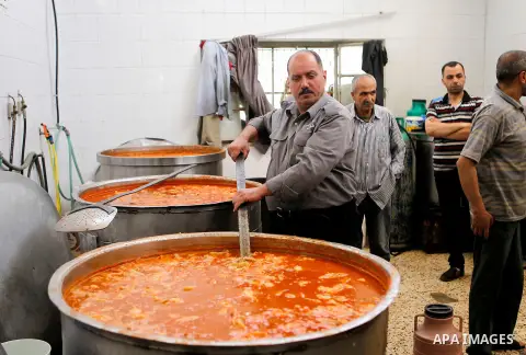 Palestinians prepare food to be distributed for free during the holy fasting month of Ramadan in the West Bank city of Hebron, 13 June 2016. the "Ibrahimi Takiya" was founded in 960 AD as an institute provides food for o...