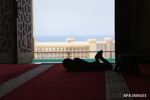A Palestinian boy sleeps, at the al-Khaldi mosque during the Muslim fasting month of Ramadan, in Gaza City on June 13, 2016. Photo by Mohammed Asad