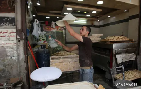 A Palestinian man prepares a traditional bread, during the Muslim fasting month of Ramadan, in the West Bank city of Nablus, on June 14, 2016. Photo by Nedal Eshtayah
