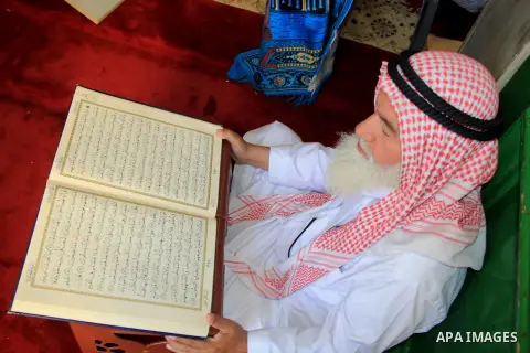 A Palestinian man reads the Koran, Islam's holy book, at al-Aqsa mosque during the holy month of Ramadan, in Jerusalem's old city on June 14, 2016. Ramadan is sacred to Muslims because it is during that month that tradit...