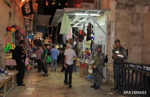 Palestinians walk at street following "Taraweeh", nightly prayer of the month of Ramadan, at al-Aqsa mosque, in Jerusalem's old city on June 14, 2016. Ramadan is sacred to Muslims because it is during that month that tra...