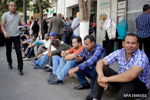 Egyptians Who obtained master's degree hold placards and shout slogans during a protest to demand jobs in Cairo, Egypt, on June 15, 2016. Photo by Amr Sayed