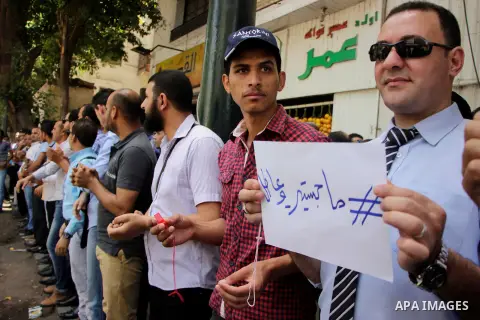 Egyptians Who obtained master's degree hold placards and shout slogans during a protest to demand jobs in Cairo, Egypt, on June 15, 2016. Photo by Amr Sayed