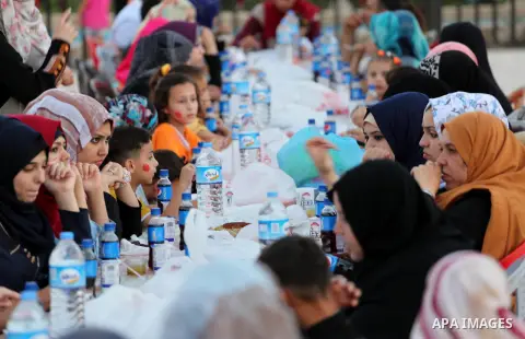 Palestinian Muslims eat their Iftar meal as they break their fast during the holy fasting month of Ramadan, in Gaza city on June 15, 2016. Ramadan is sacred to Muslims because it is during that month that tradition says...