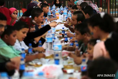 Palestinian Muslims eat their Iftar meal as they break their fast during the holy fasting month of Ramadan, in Gaza city on June 15, 2016. Ramadan is sacred to Muslims because it is during that month that tradition says...