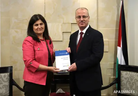 Palestinian Prime Minister Rami Hamdallah receives the Annual report of the Independent Commission for Human Rights for 2015, in the West Bank city of Ramallah on June 16, 2016. Photo by Prime Minister Office