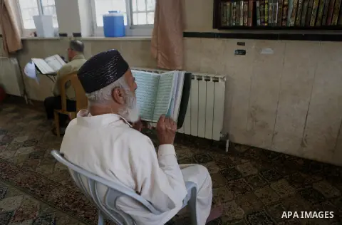 Palestinian Muslim men read the holy Koran, Islam's holy book at a mosque on the holy month of Ramadan in the West bank city of Ramallah, on June 16, 2016. Ramadan is sacred to Muslims because it is during that month tha...