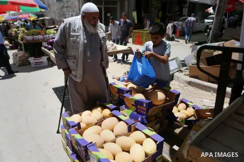 A Palestinian vendor sells fruits at a market on the holy month of Ramadan in the West bank city of Ramallah, on June 16, 2016. Ramadan is sacred to Muslims because it is during that month that tradition says the Koran w...