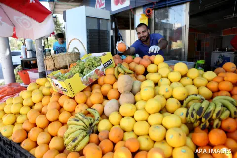 A Palestinian vendor sells fruits at a market on the holy month of Ramadan in the West bank city of Ramallah, on June 16, 2016. Ramadan is sacred to Muslims because it is during that month that tradition says the Koran w...