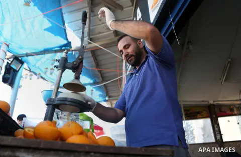 A Palestinian vendor prepares orange juice on the holy month of Ramadan at a market in the West bank city of Ramallah, on June 16, 2016. Ramadan is sacred to Muslims because it is during that month that tradition says th...