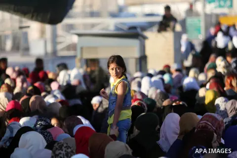 Palestinian women wait to cross the Qalandia checkpoint between the West Bank city of Ramallah and Jerusalem on June 17, 2016, as they head to Jerusalem's Al-Aqsa mosque for the second Friday prayer of the holy Muslim fa...